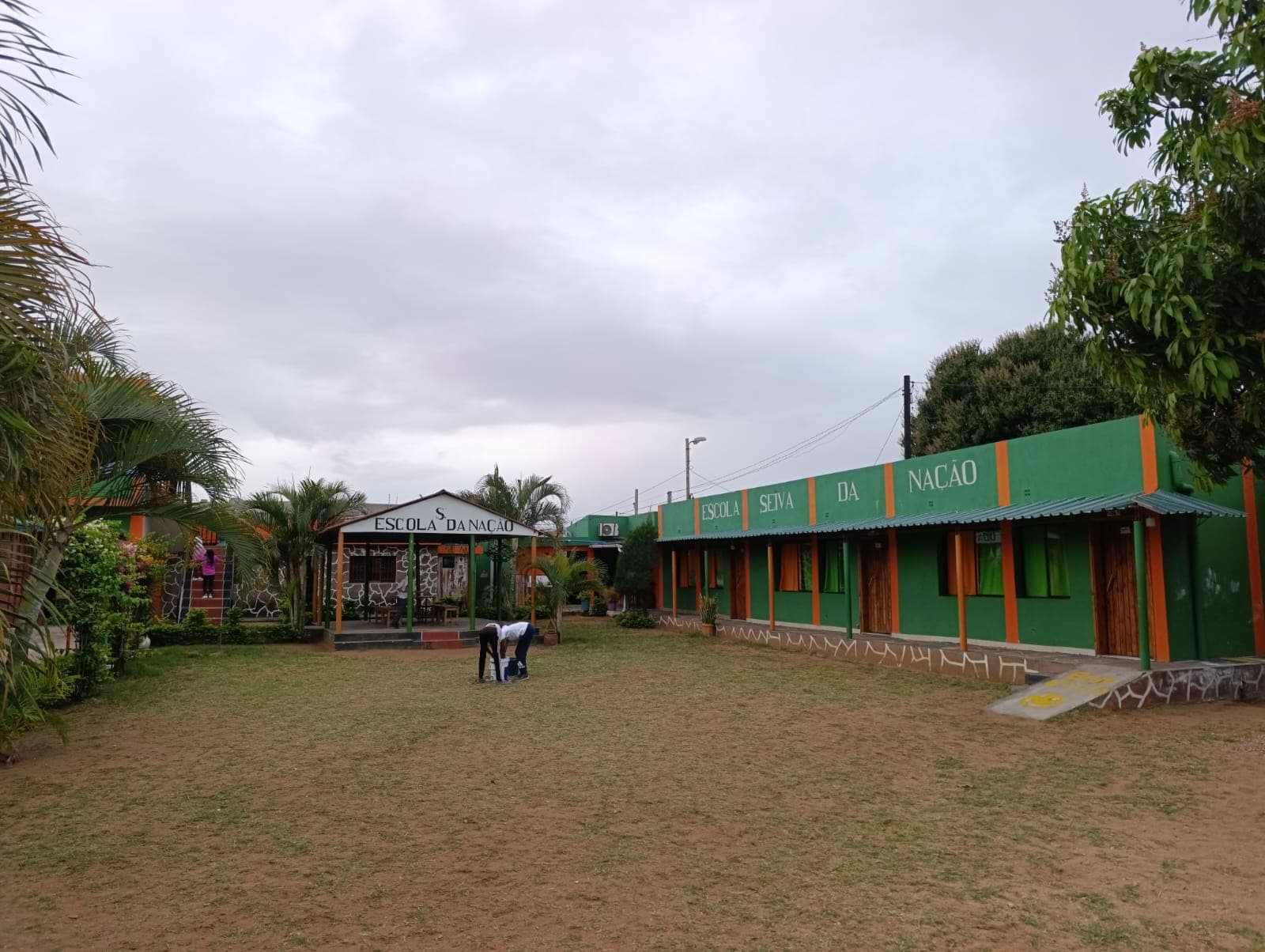 As mãos a acenar para a câmara, no meio do recreio.